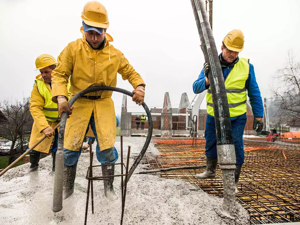 Construction workers pouring cement